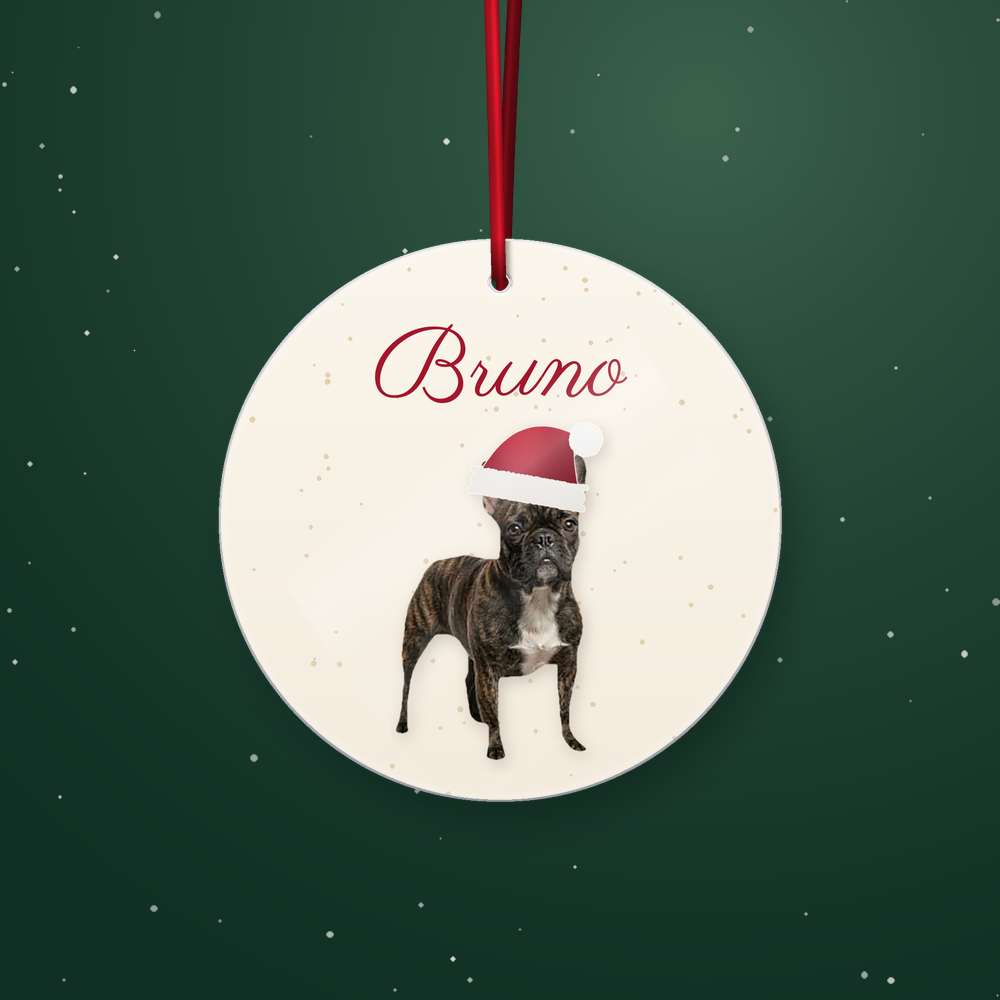 Personalized round Christmas dog ornament with a red ribbon and Santa hat